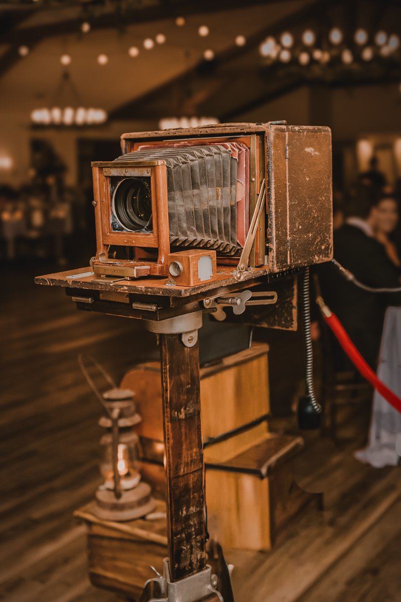 The restored Rochester Optical bellows camera housing on its stand.